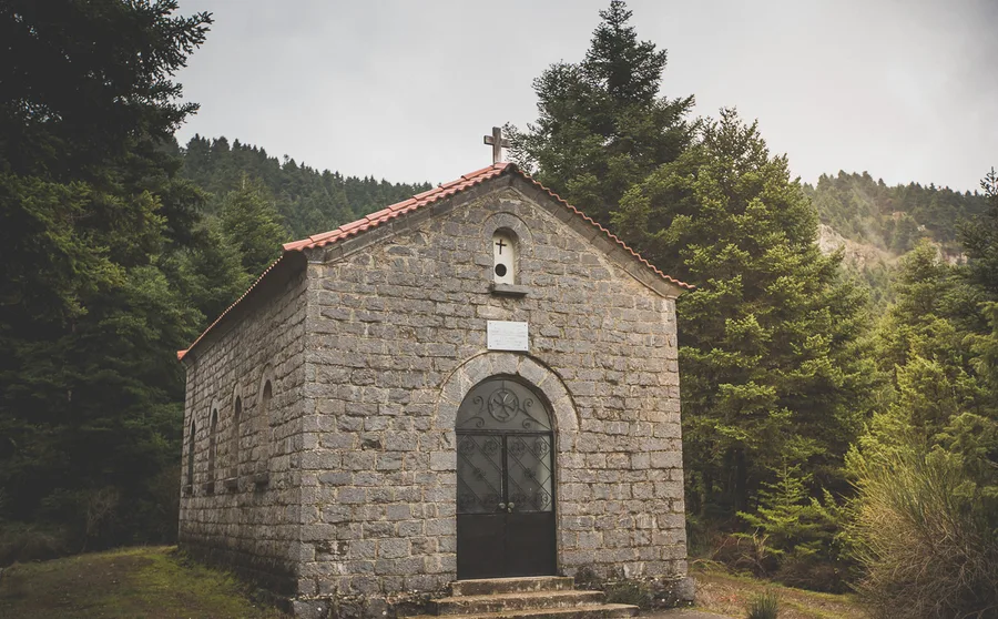 A small stone chapel among the firs