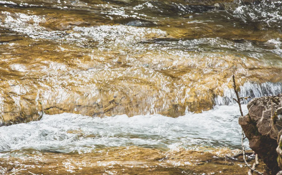 Water pouring over a low ledge of rock