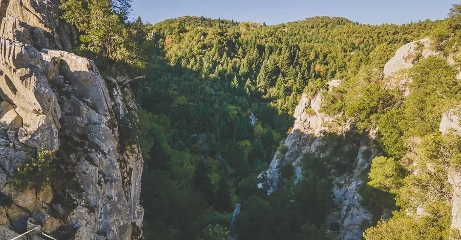 A narrow gorge with a waterfall, from above