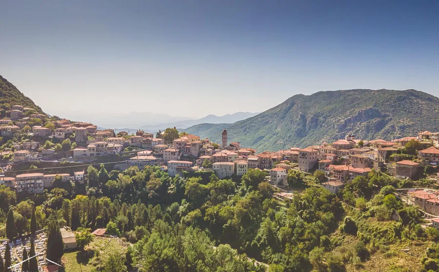 A village above the valley under a clear sky