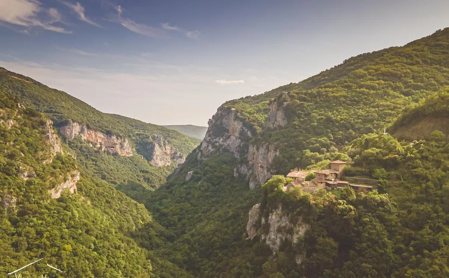 A wooded gorge with a monastery on its slope
