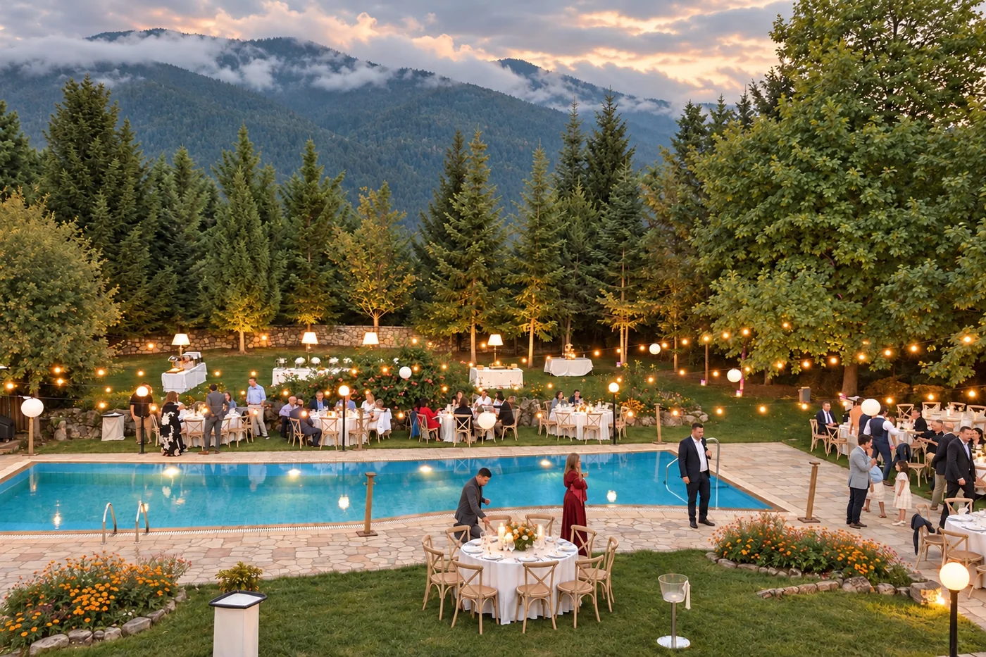 The reception at dusk, with guests around the pool and the cloud-covered mountain behind