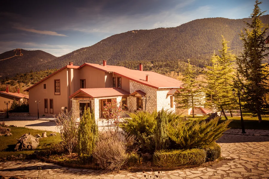 Stone and timber buildings with the mountain behind them