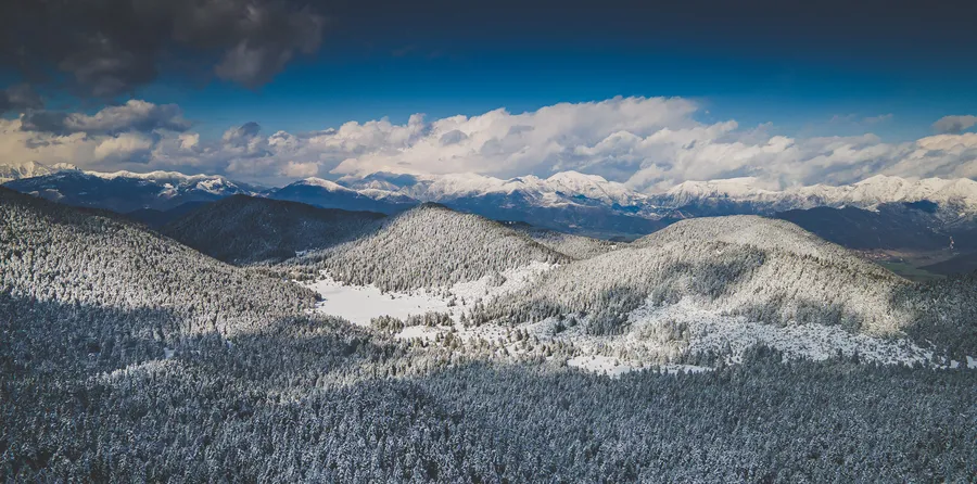 Snowy ridges under a blue sky, from above