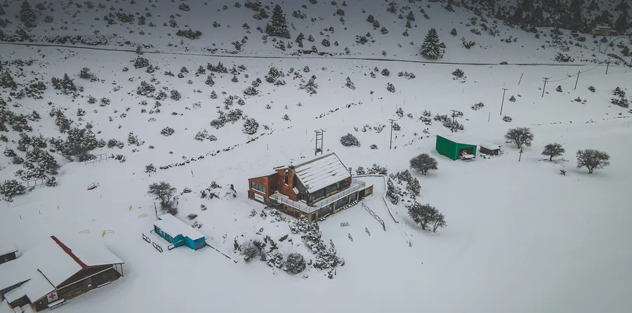 Mountain buildings in deep snow, from above