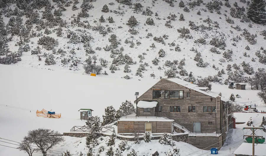 The ski centre building and a lift on a snowy slope